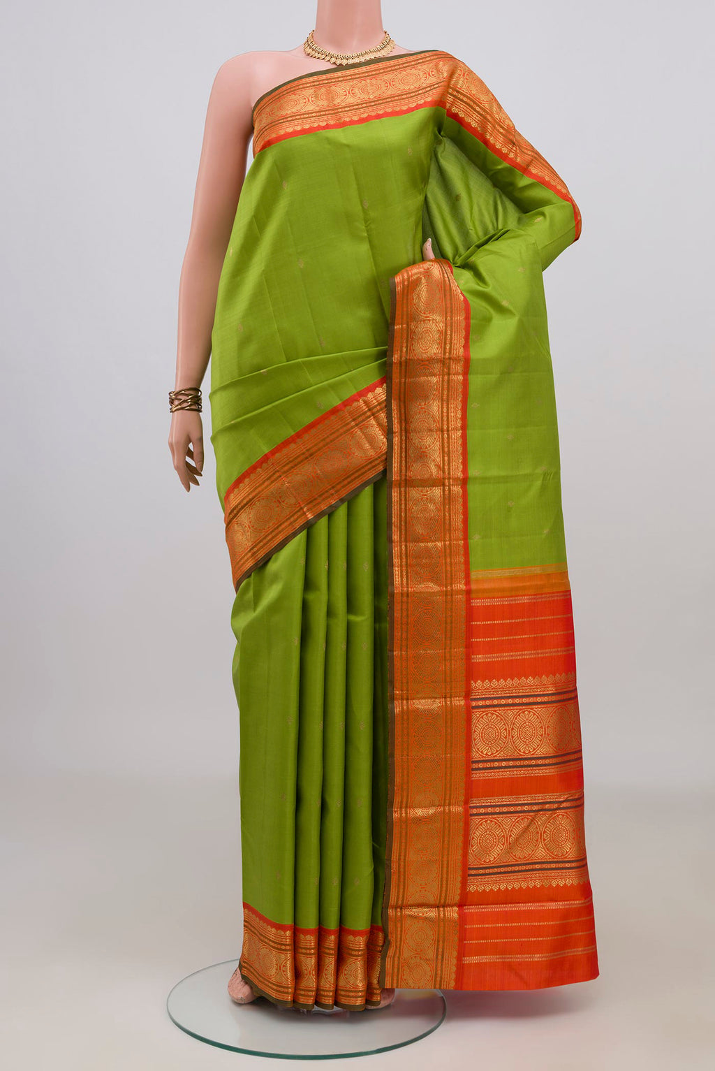 Pure Silk Pure Zari Parrot Green Kanjivaram Saree with Zari Butta on the body and Zari Border.  displayed on a mannequin