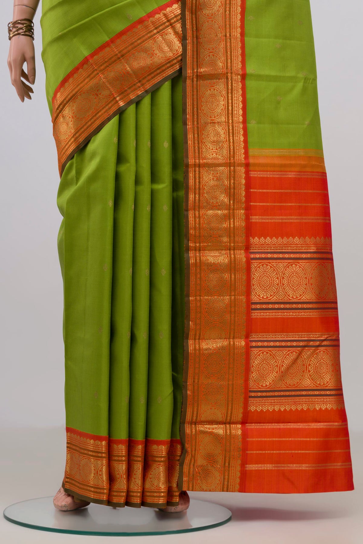 Pleats and pallu of Pure Silk Pure Zari Parrot Green Kanjivaram Saree with Zari Butta on the body and Zari Border. 