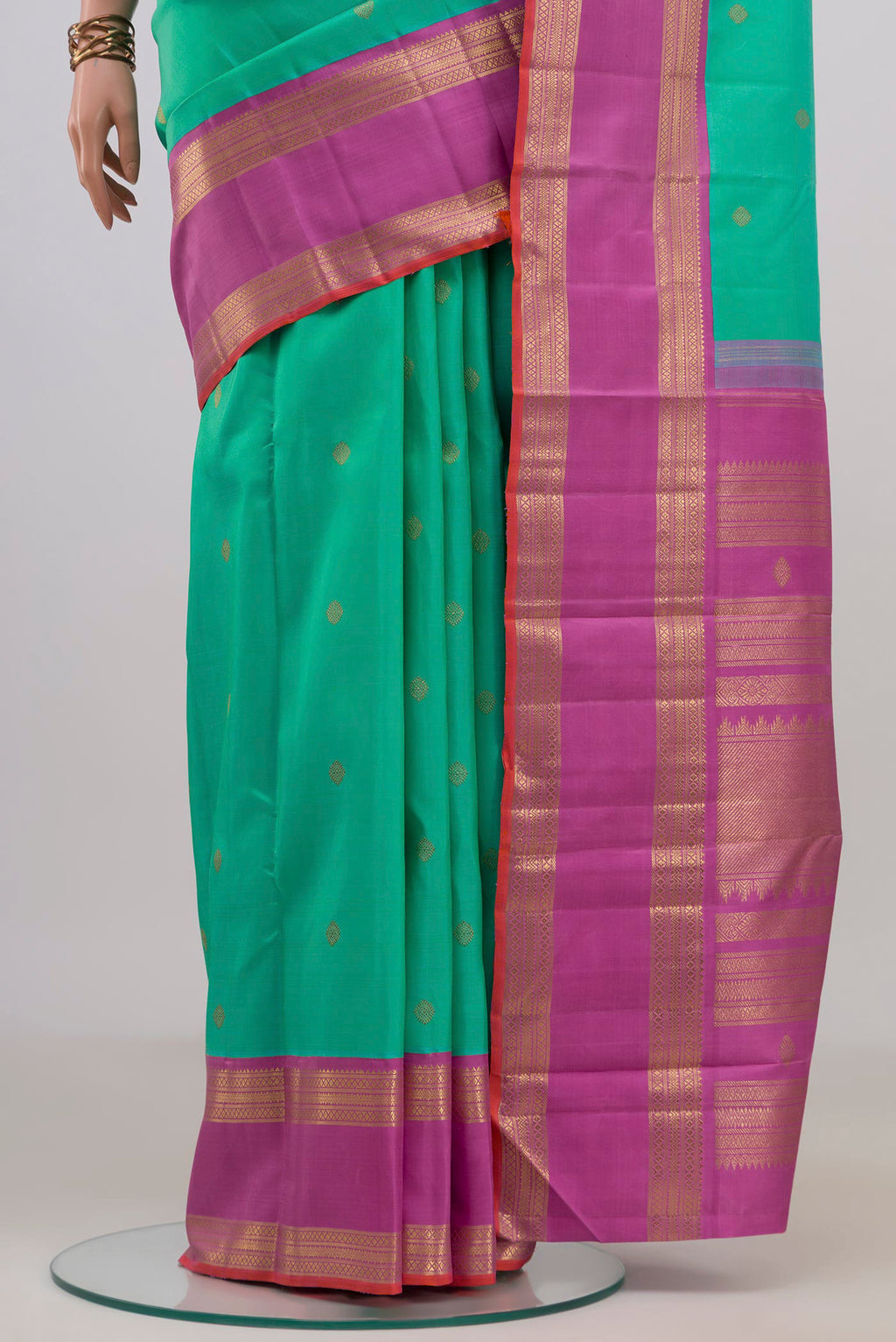 Pleats and pallu of Pure Silk Pure Zari Green Kanjivaram Saree with Zari Butta on the body and Zari Border. 