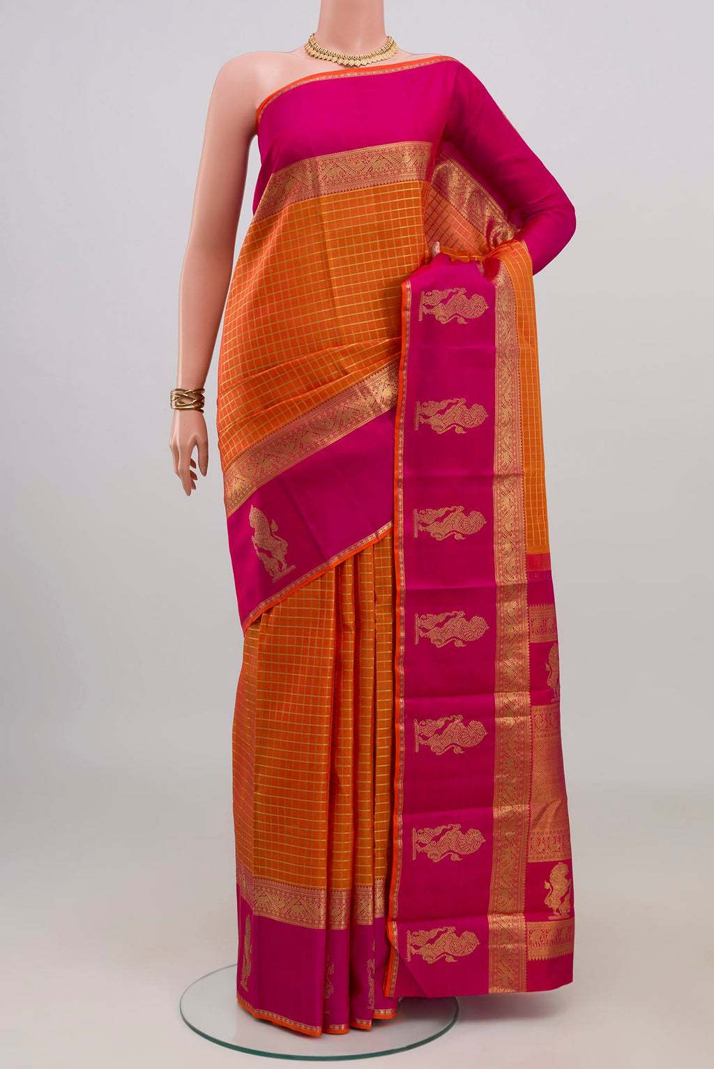 Pure Silk Pure Zari Orange Kanjivaram Saree with Checked design on the body and Zari Border.  displayed on a mannequin