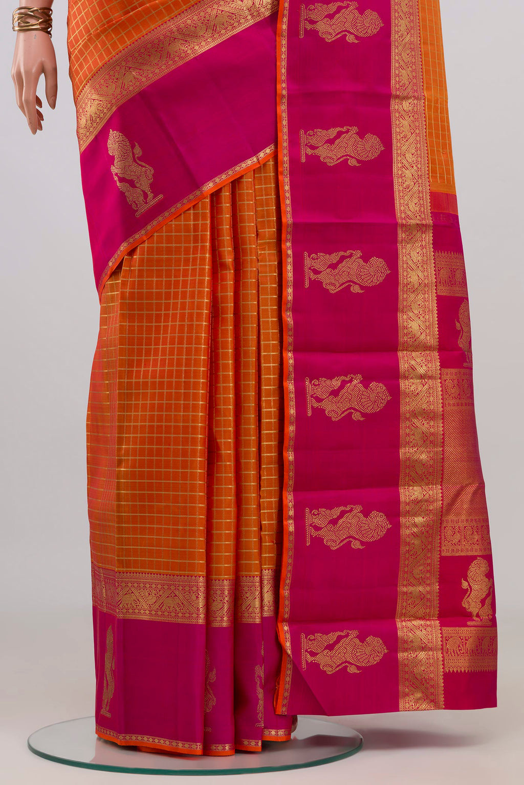 Pleats and pallu of Pure Silk Pure Zari Orange Kanjivaram Saree with Checked design on the body and Zari Border. 
