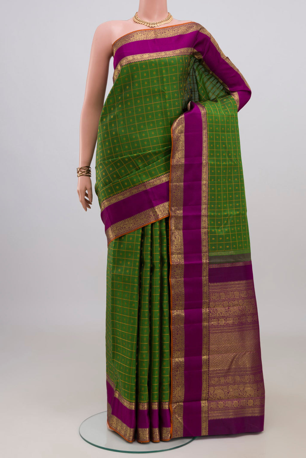 Pure Silk Pure Zari Green Kanjivaram Saree with Checked design on the body and Zari Border.  displayed on a mannequin