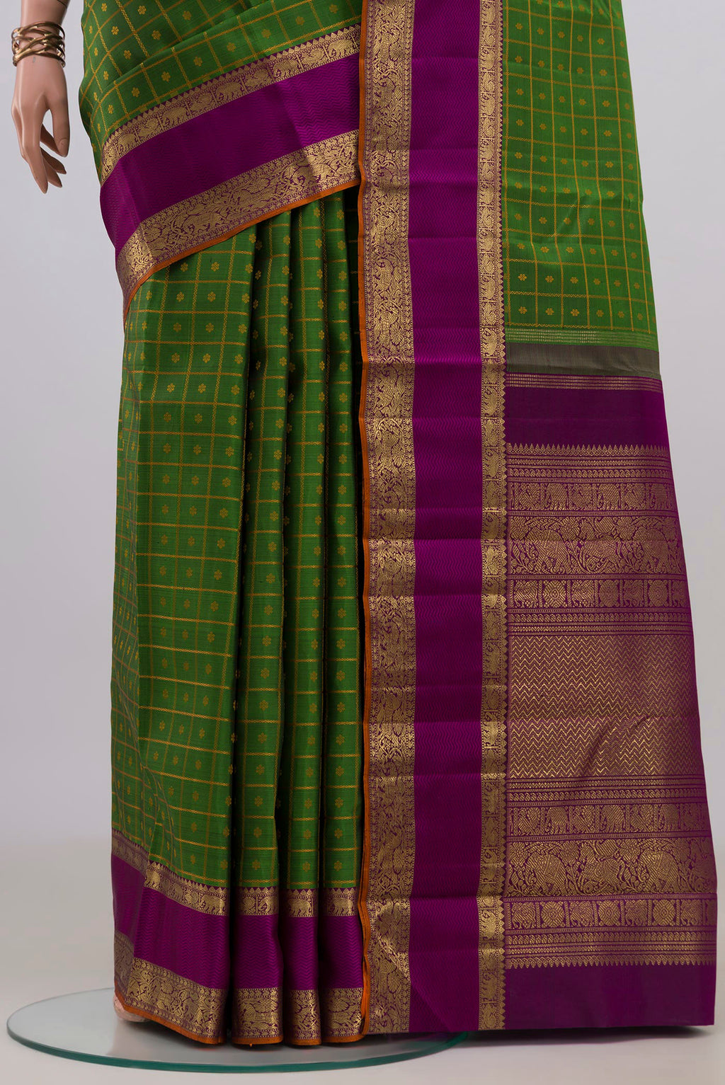 Pleats and pallu of Pure Silk Pure Zari Green Kanjivaram Saree with Checked design on the body and Zari Border. 