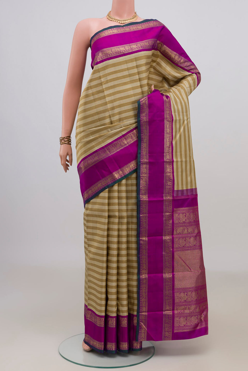 Pure Silk Pure Zari Beige Kanjivaram Saree with Stripes on the body and Zari Border.  displayed on a mannequin