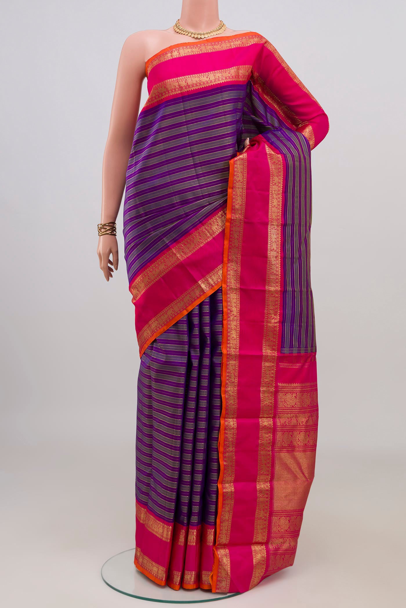 Pure Silk Pure Zari Purple Kanjivaram Saree with Stripes on the body and Zari Border.  displayed on a mannequin