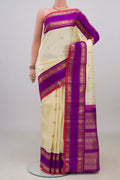 Pure Silk Pure Zari Off White Kanjivaram Saree with Zari Butta on the body and Zari Border.  displayed on a mannequin