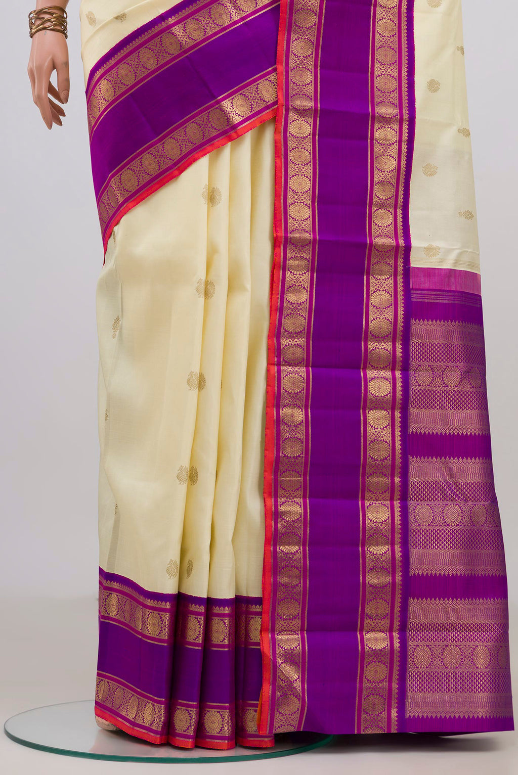 Pleats and pallu of Pure Silk Pure Zari Off White Kanjivaram Saree with Zari Butta on the body and Zari Border. 