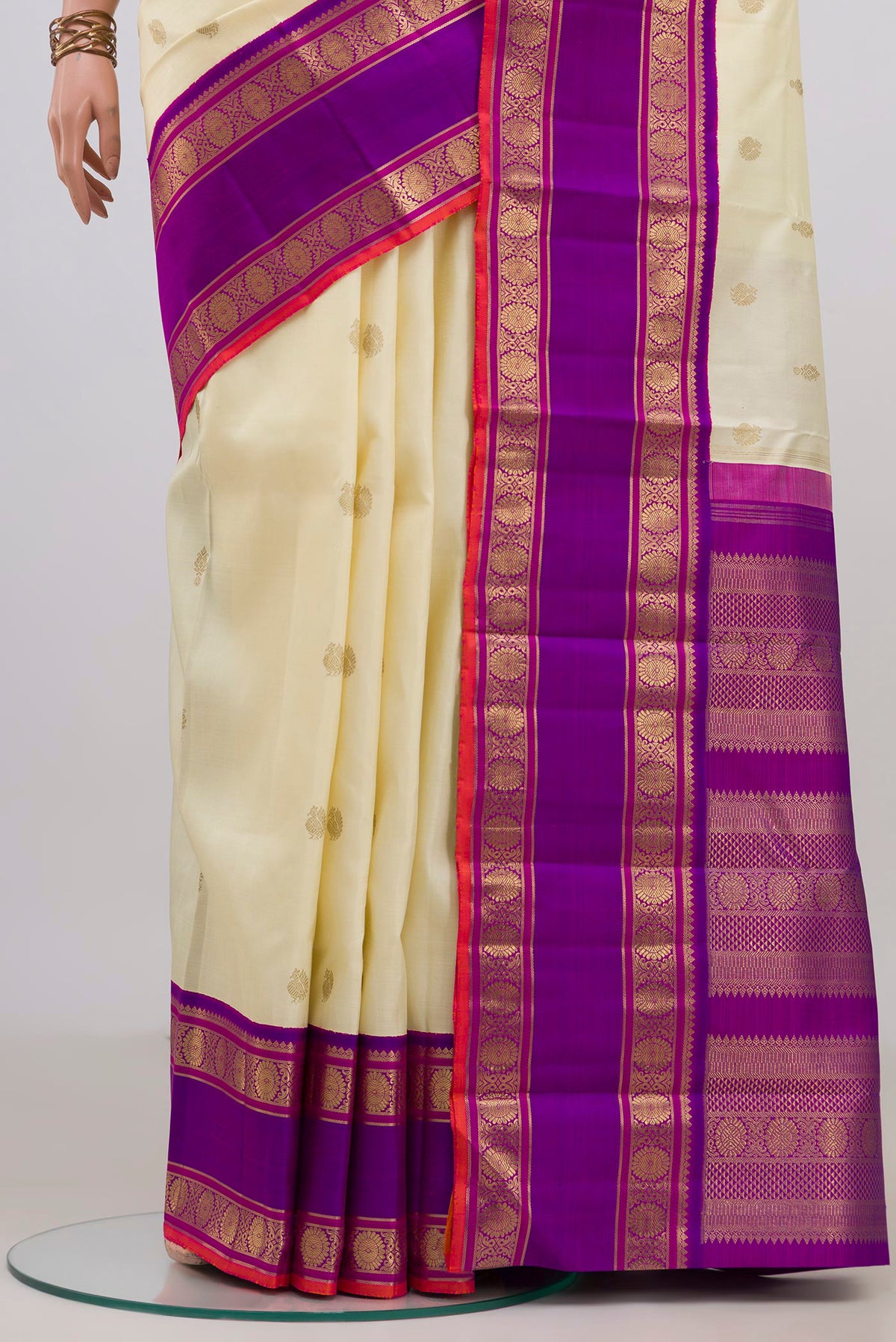 Pleats and pallu of Pure Silk Pure Zari Off White Kanjivaram Saree with Zari Butta on the body and Zari Border. 