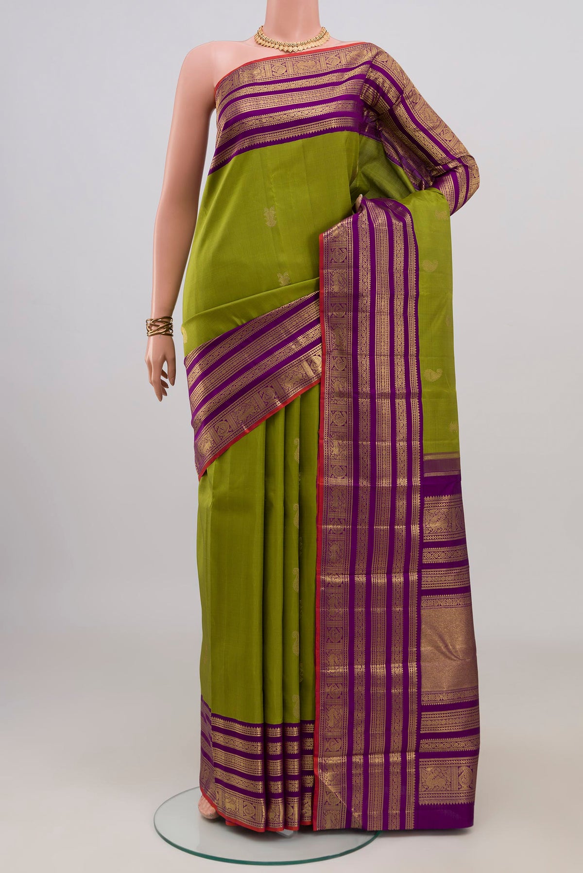 Pure Silk Pure Zari Green Kanjivaram Saree with Zari Butta on the body and Zari Border.  displayed on a mannequin