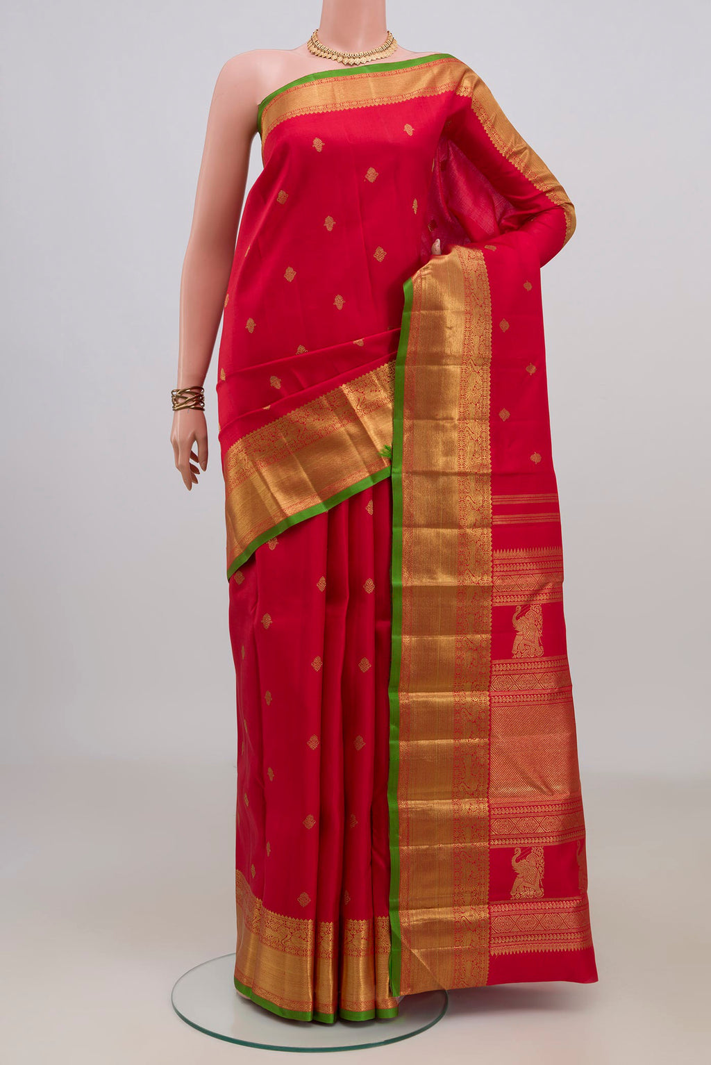 Pure Silk Pure Zari Red Kanjivaram Saree with Zari Butta on the body and Zari Border.  displayed on a mannequin
