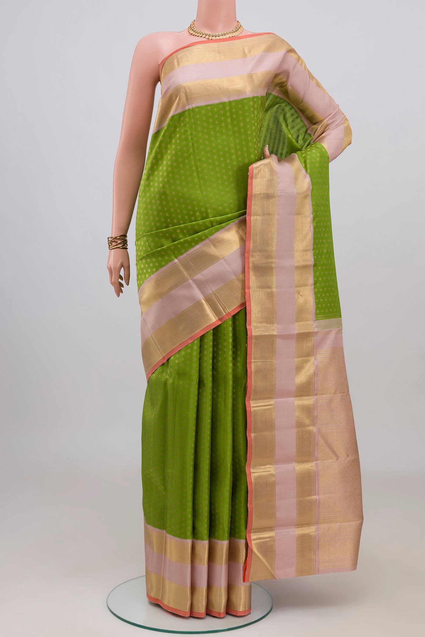 Pure Silk Pure Zari Green Kanjivaram Saree with Zari Butta on the body and Zari Border.  displayed on a mannequin