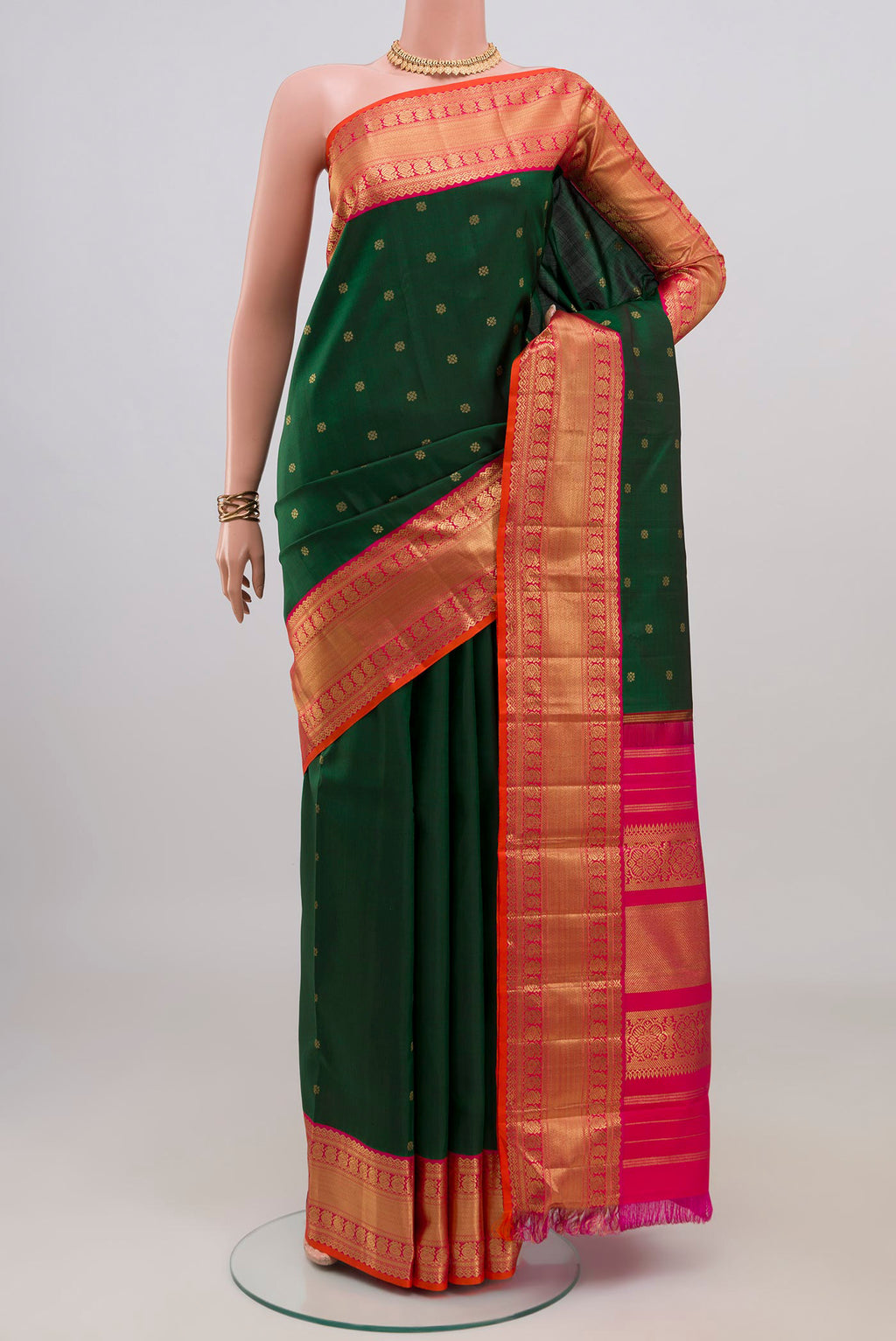 Pure Silk Pure Zari Bottle Green Kanjivaram Saree with Zari Butta on the body and Zari Border.  displayed on a mannequin