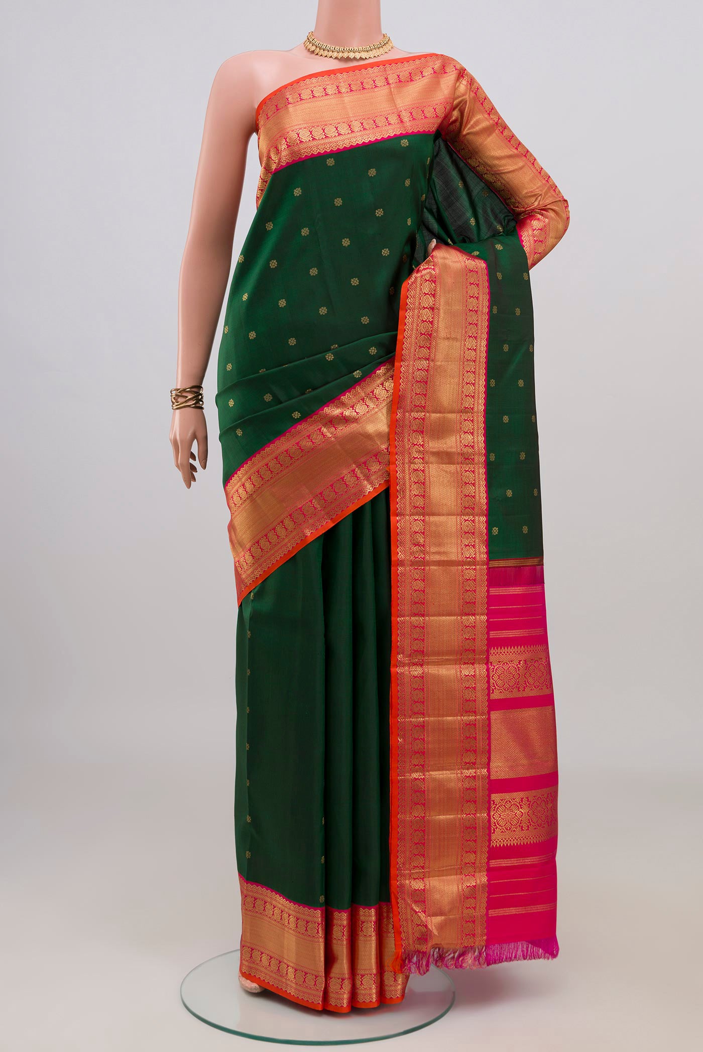 Pure Silk Pure Zari Bottle Green Kanjivaram Saree with Zari Butta on the body and Zari Border.  displayed on a mannequin