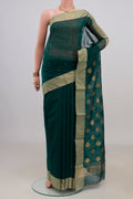 Bottle Green Chanderi Cotton Saree with Zari Butta on the body and Zari Border.  displayed on a mannequin