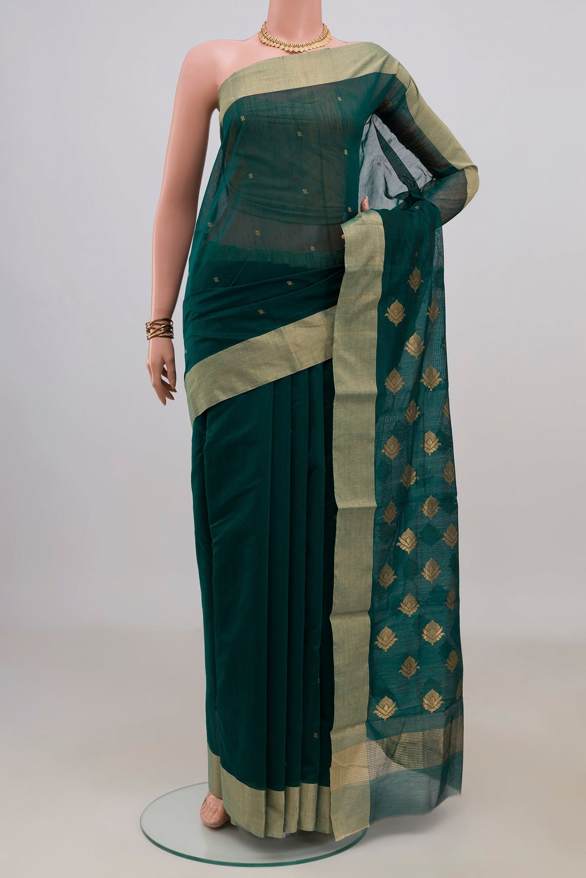 Bottle Green Chanderi Cotton Saree with Zari Butta on the body and Zari Border.  displayed on a mannequin