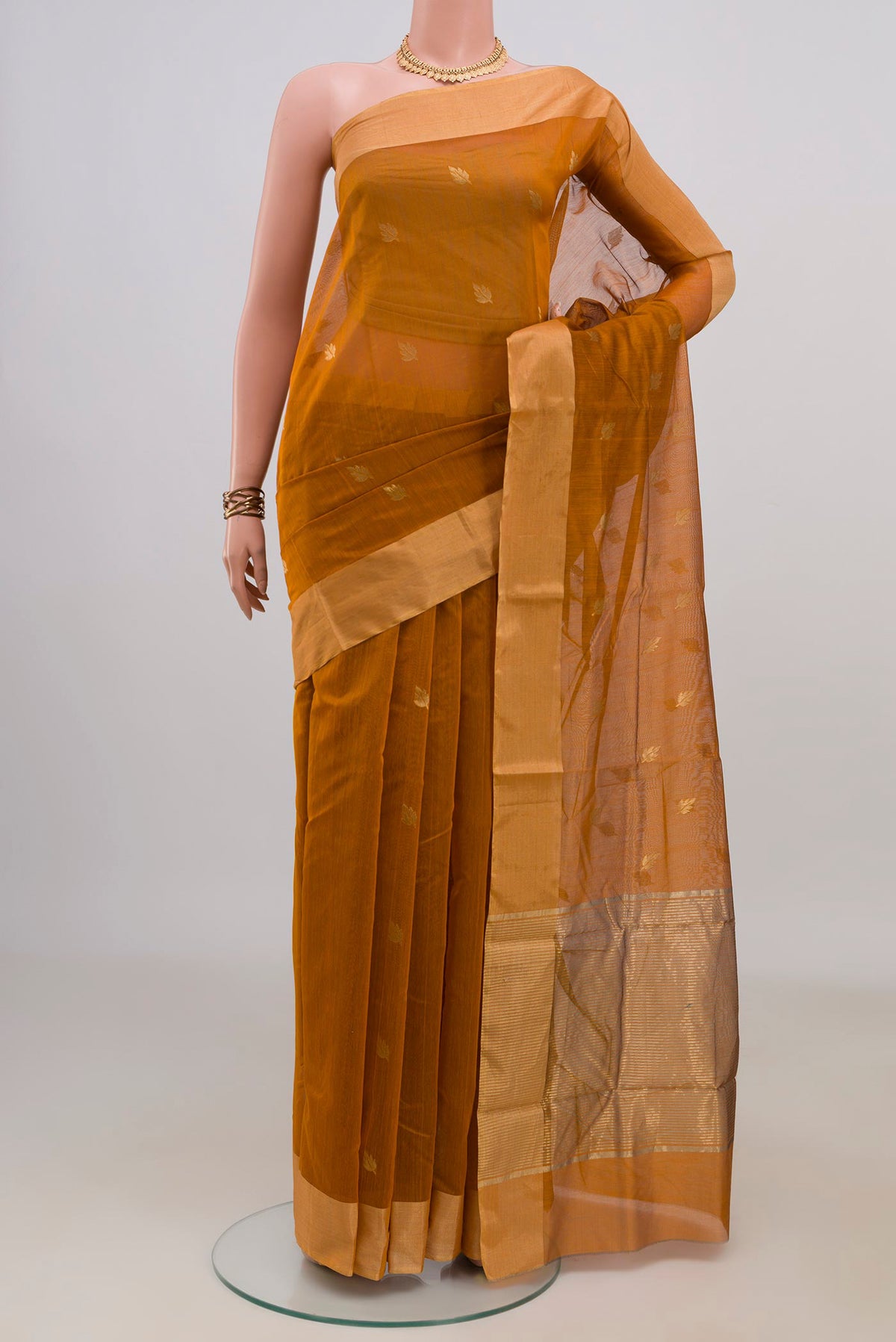 Mustard Chanderi Cotton Saree with Zari Butta on the body and Zari Border.  displayed on a mannequin