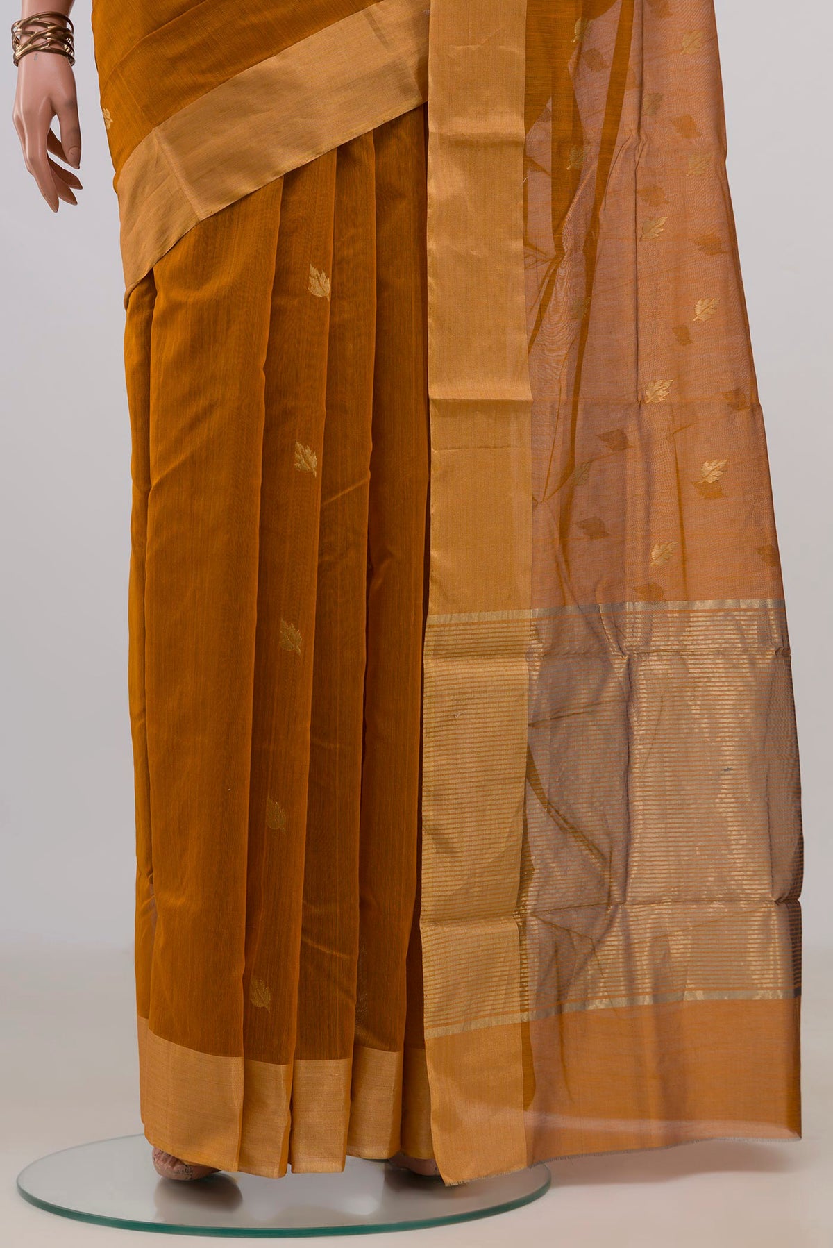 Pleats and pallu of Mustard Chanderi Cotton Saree with Zari Butta on the body and Zari Border. 