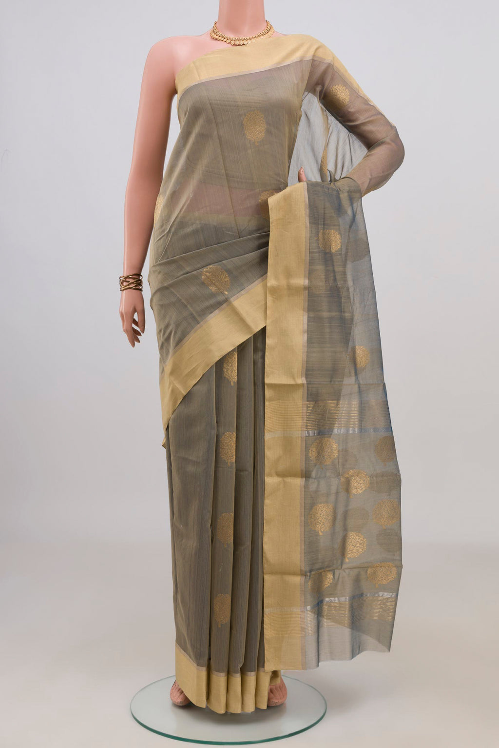 Green Chanderi Cotton Saree with Zari Butta on the body and Zari Border.  displayed on a mannequin