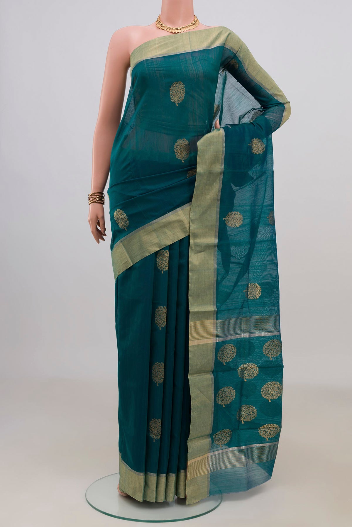 Teal Chanderi Cotton Saree with Zari Butta on the body and Zari Border.  displayed on a mannequin