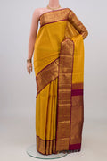Yellow Kanjivaram Silk Saree with Checked design on the body and Zari Border.  displayed on a mannequin