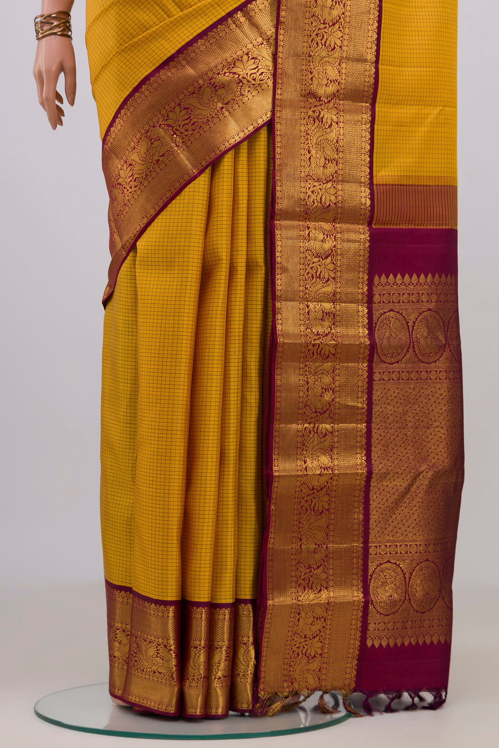 Pleats and pallu of Yellow Kanjivaram Silk Saree with Checked design on the body and Zari Border. 