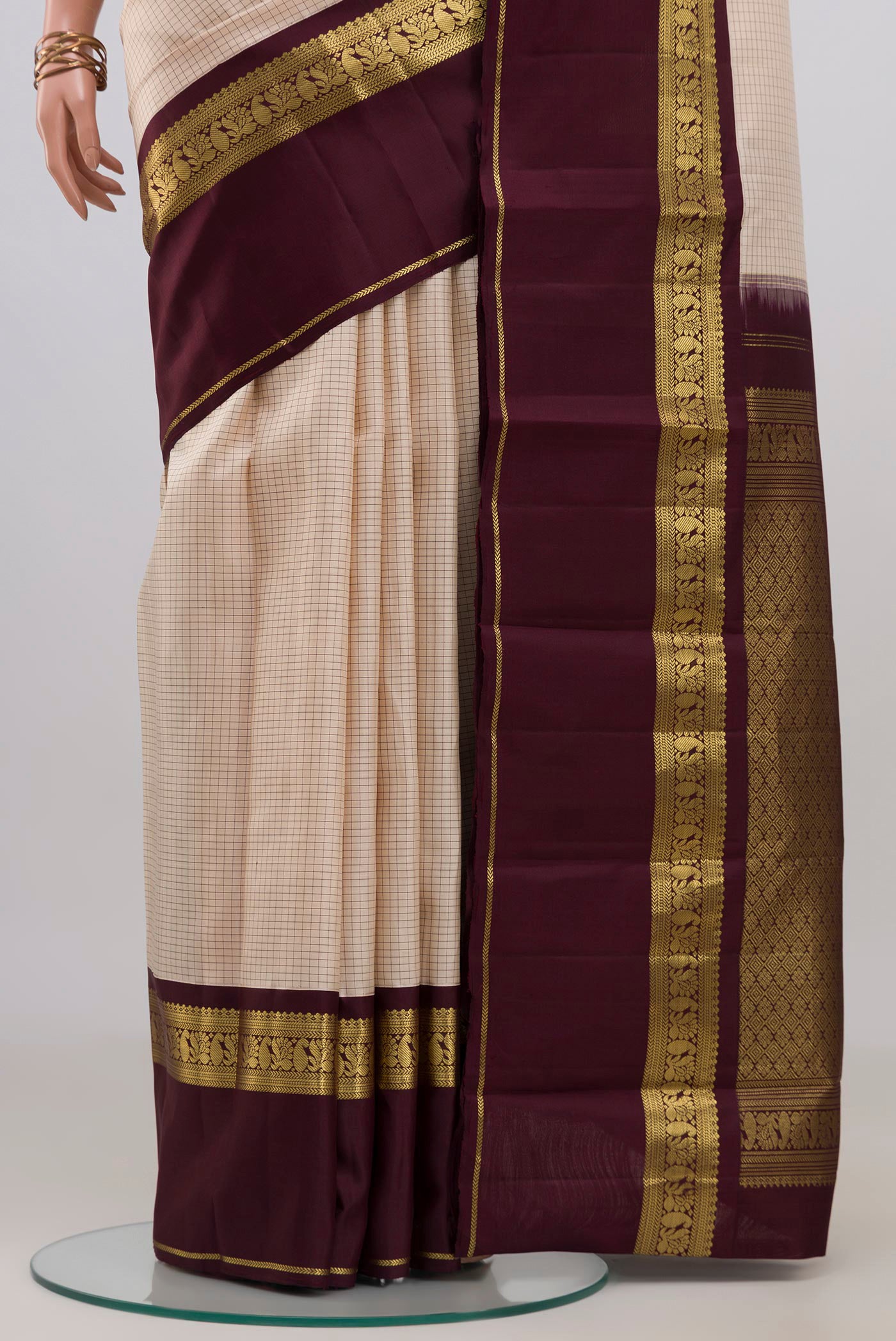 Pleats and pallu of Cream Kanjivaram Silk Saree with Checked design on the body and Zari Border. 
