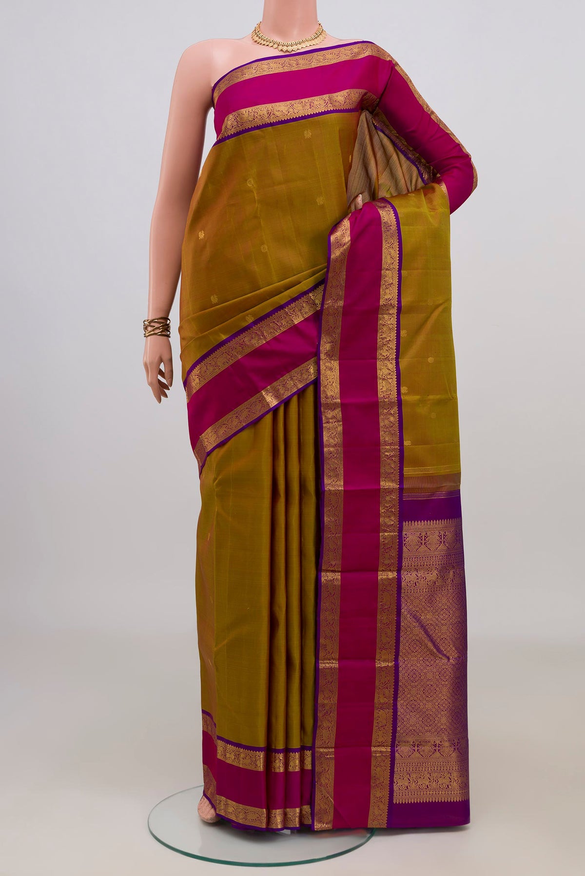 Pure Silk Pure Zari Green Dual Tone Kanchipuram Saree with Zari Butta on the body and Zari Border.  displayed on a mannequin