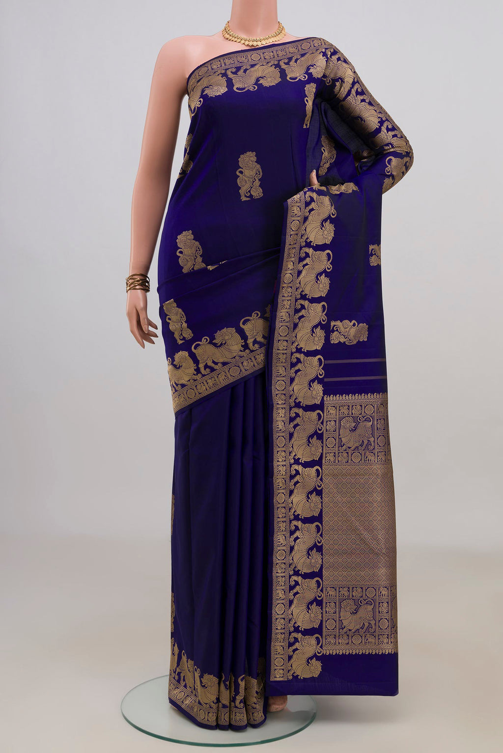 Pure Silk Blue Kanjivaram Saree with Thread Butta on the body and Thread Border.  displayed on a mannequin