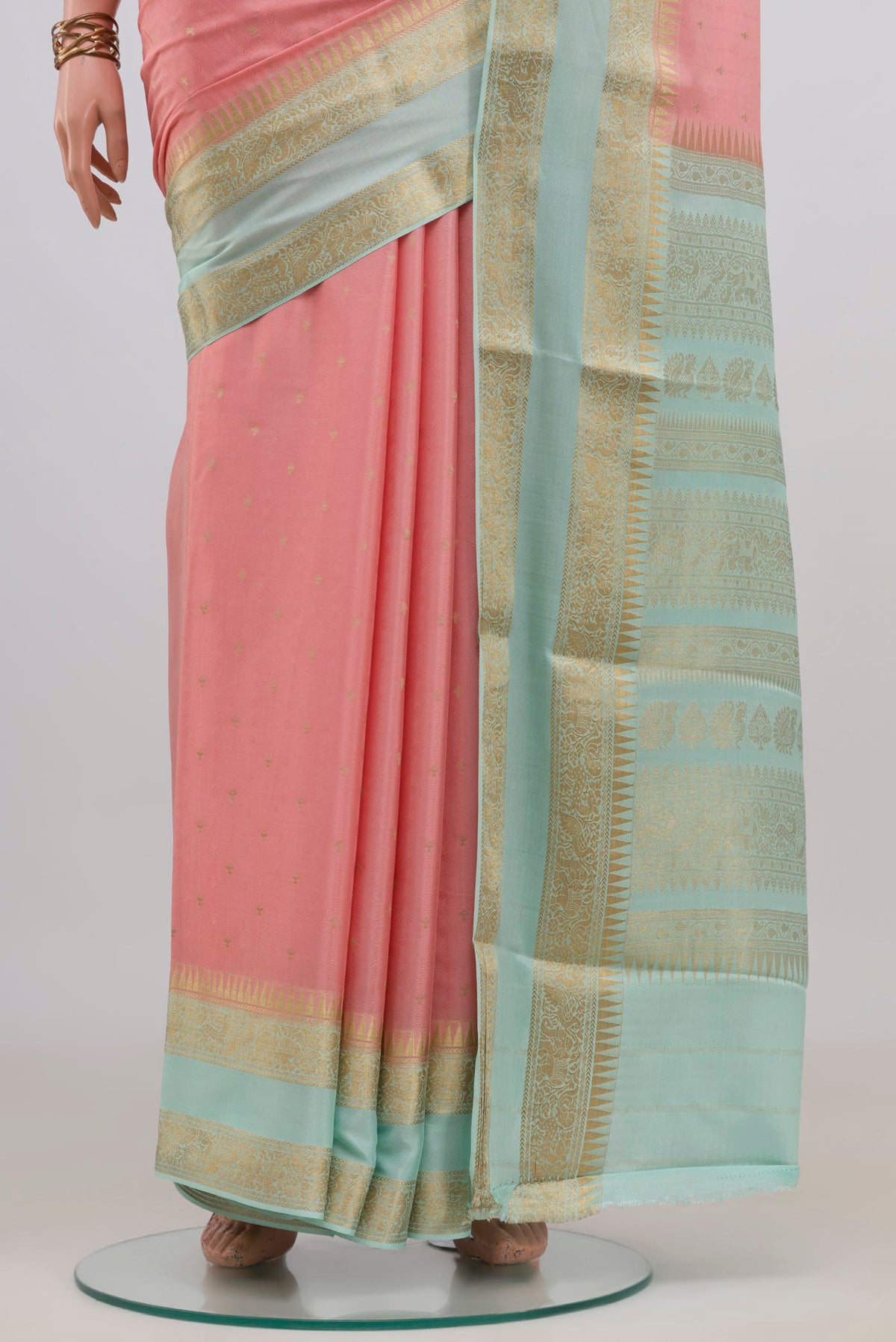 Pleats and pallu of Peach Mysore Crepe Saree with Zari Butta on the body and Zari Border. 