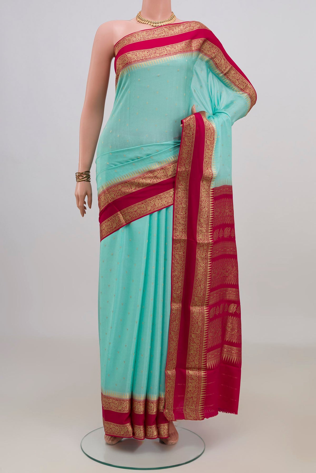Turquoise Mysore Chiffon Saree with Zari Butta on the body and Zari Border.  displayed on a mannequin