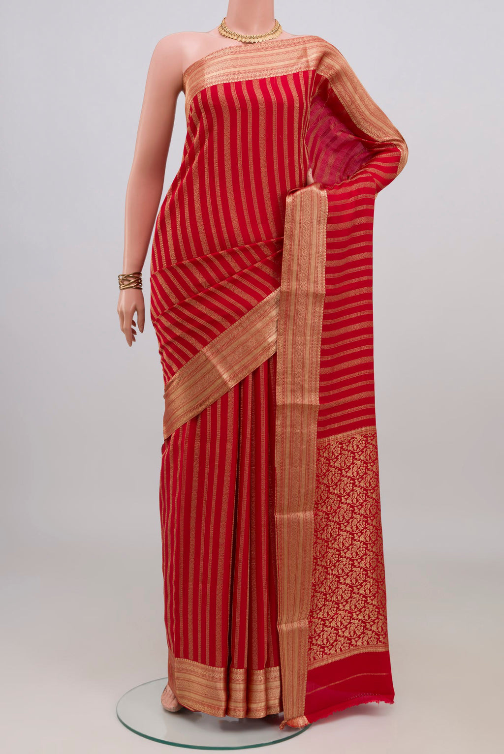 Red Mysore Crepe Saree with Stripes on the body and Zari Border.  displayed on a mannequin