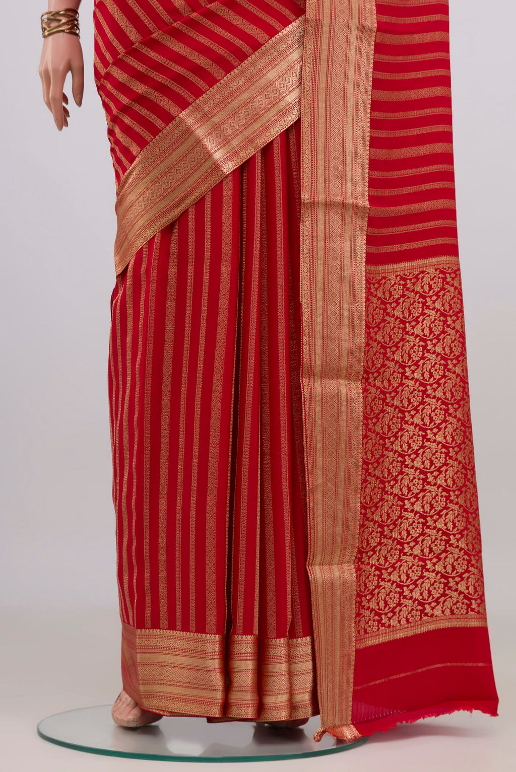 Pleats and pallu of Red Mysore Crepe Saree with Stripes on the body and Zari Border. 