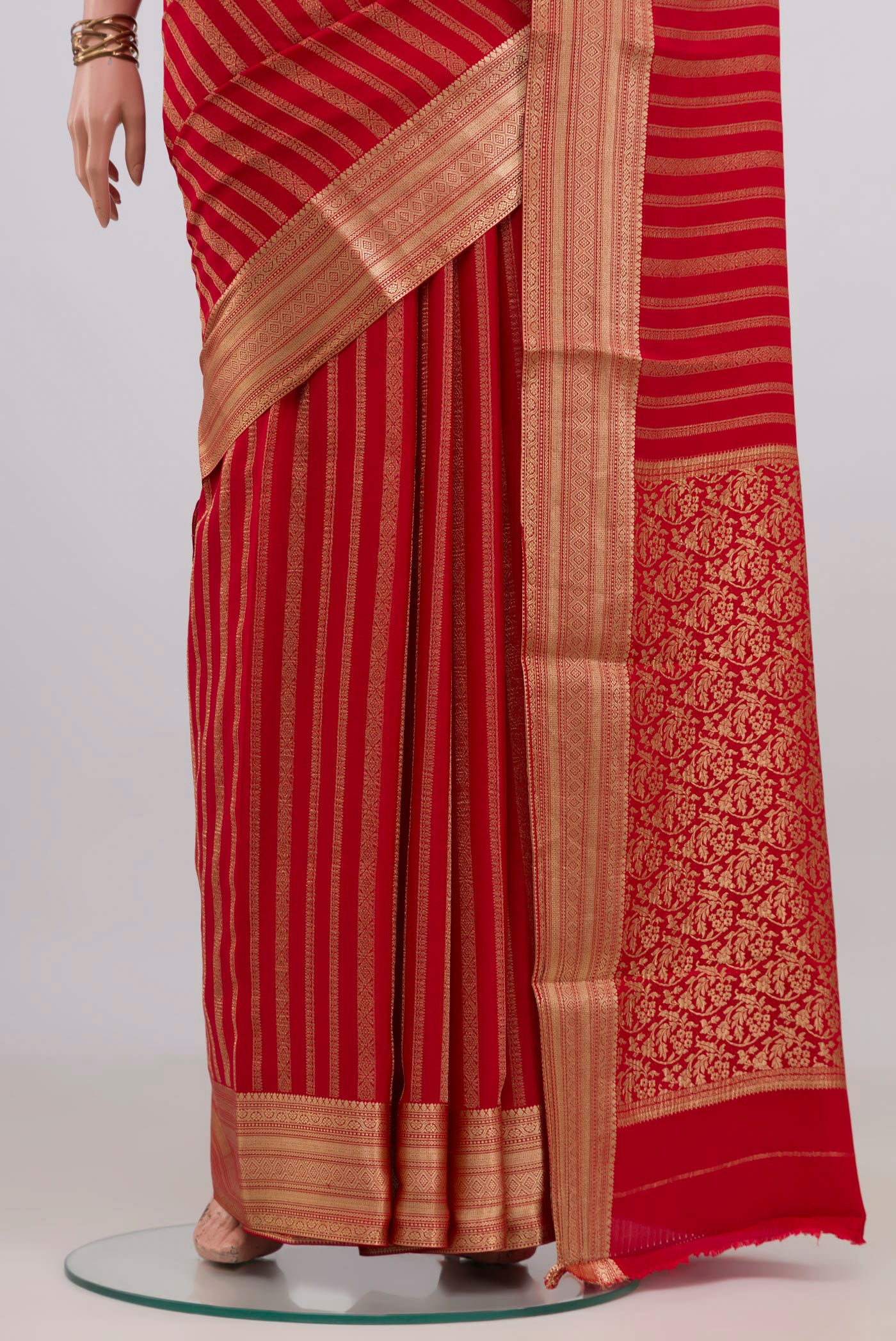 Pleats and pallu of Red Mysore Crepe Saree with Stripes on the body and Zari Border. 