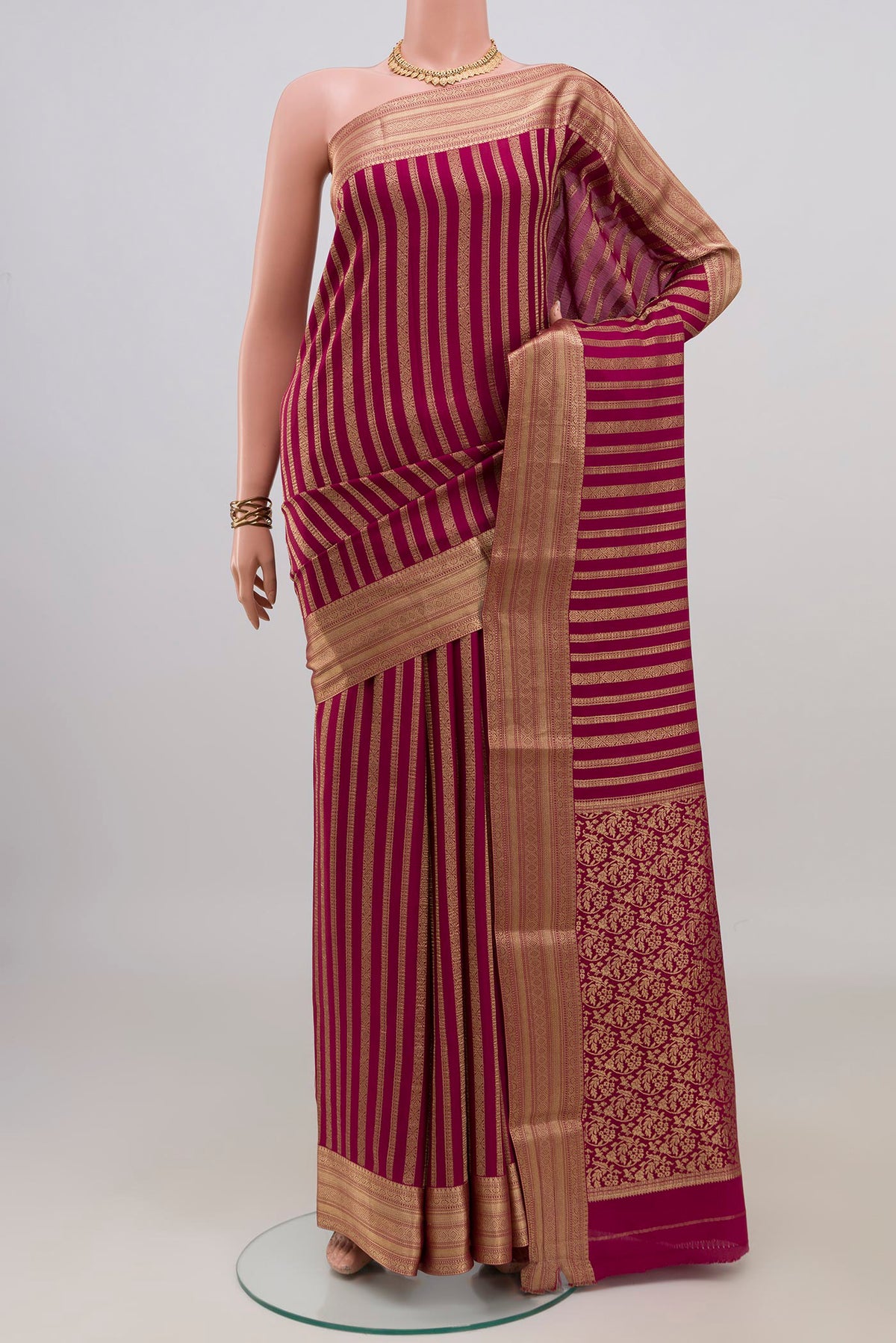 Maroon Mysore Crepe Saree with Stripes on the body and Zari Border.  displayed on a mannequin