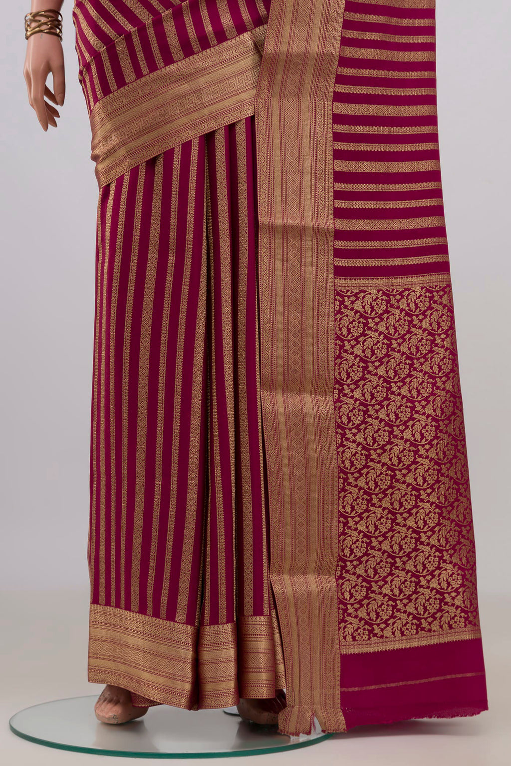 Pleats and pallu of Maroon Mysore Crepe Saree with Stripes on the body and Zari Border. 