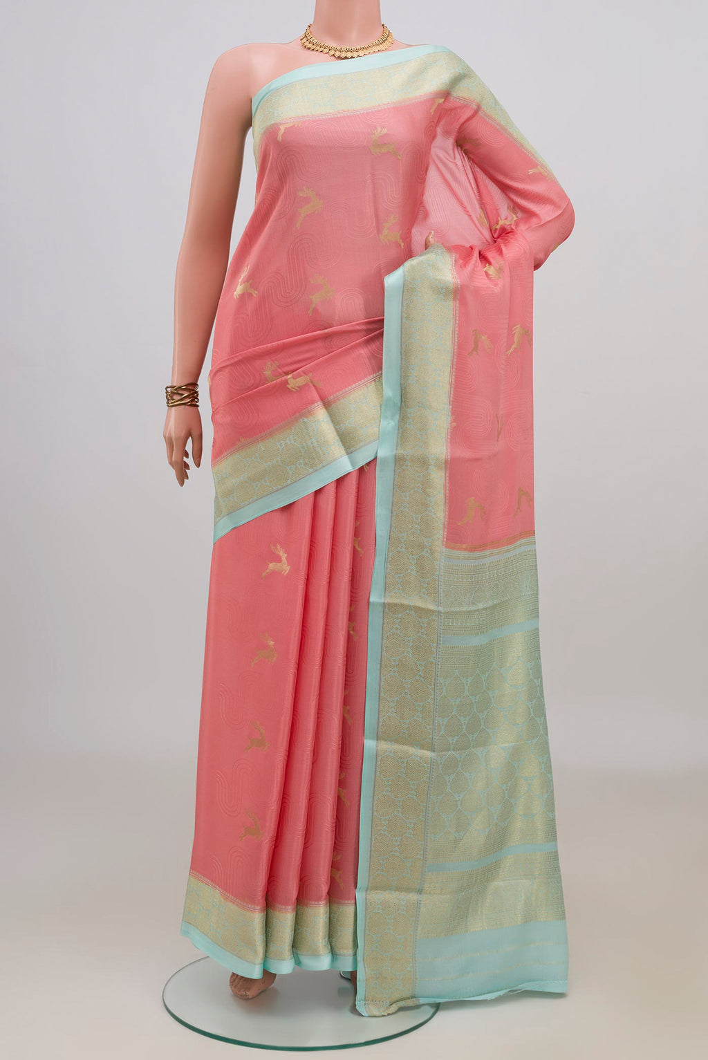 Peach Mysore Crepe Saree with Zari Butta on the body and Zari Border.  displayed on a mannequin