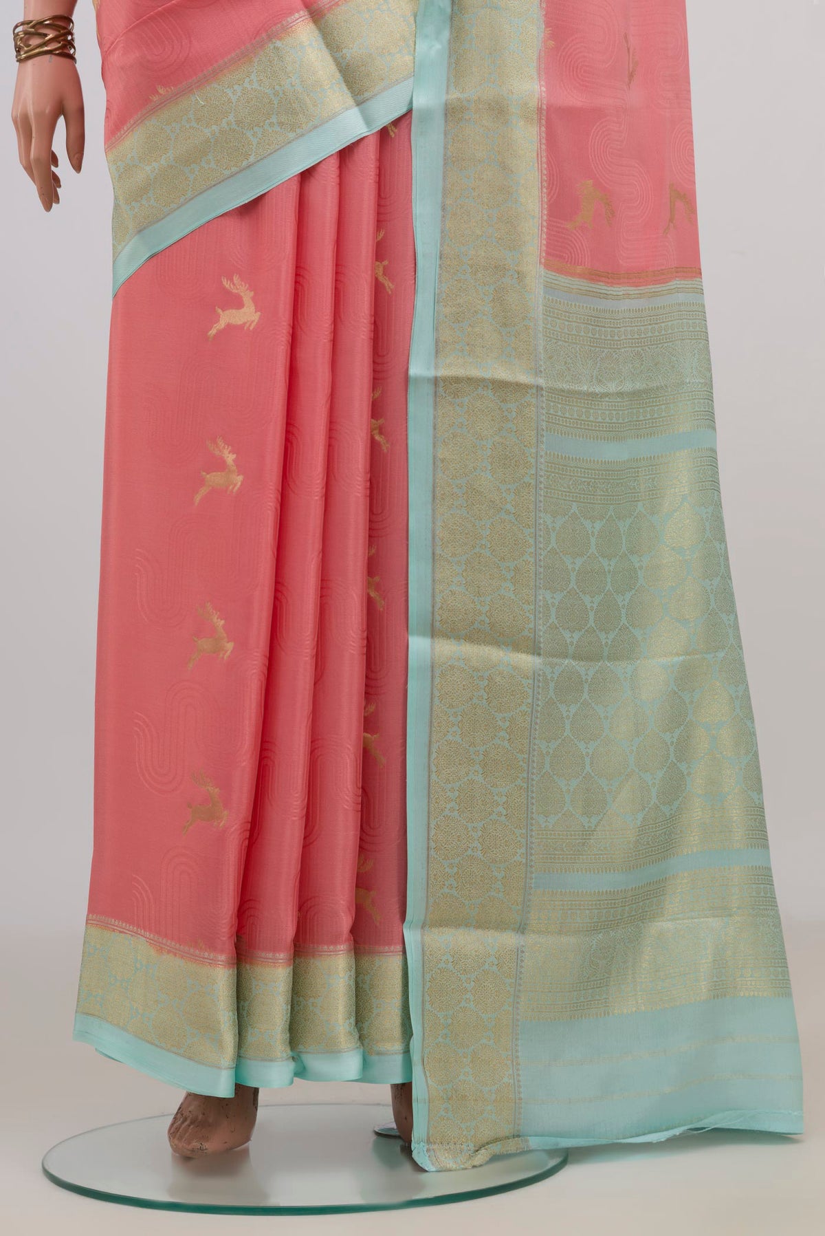 Pleats and pallu of Peach Mysore Crepe Saree with Zari Butta on the body and Zari Border. 