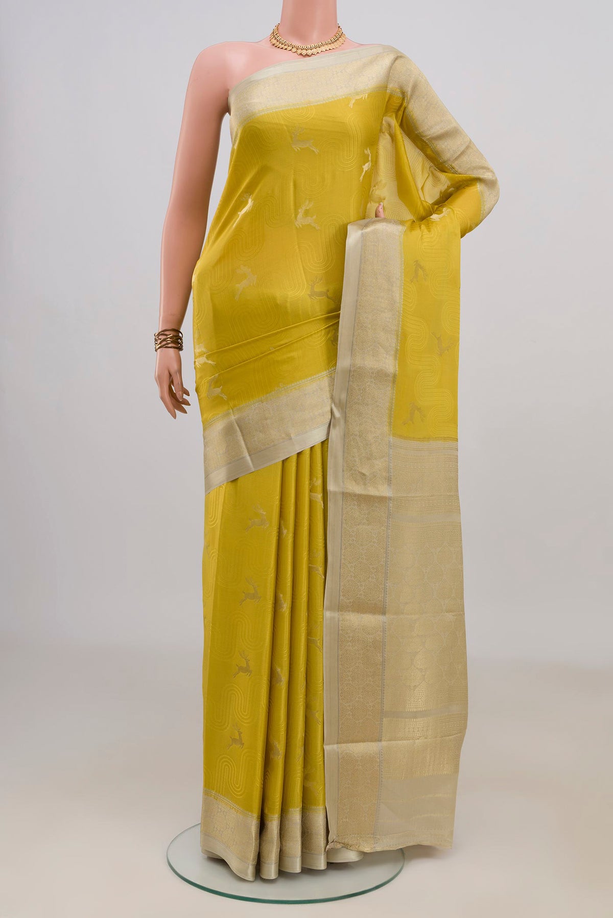 Yellow Mysore Crepe Saree with Jacquard With Zari Butta on the body and Zari Border.  displayed on a mannequin