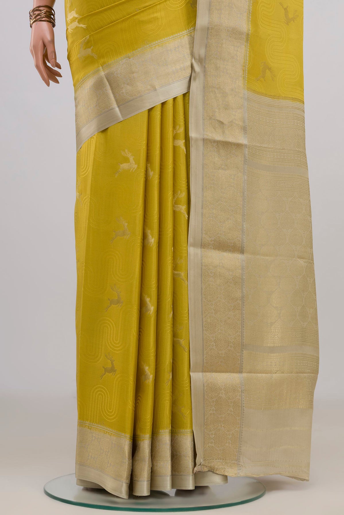 Pleats and pallu of Yellow Mysore Crepe Saree with Jacquard With Zari Butta on the body and Zari Border. 