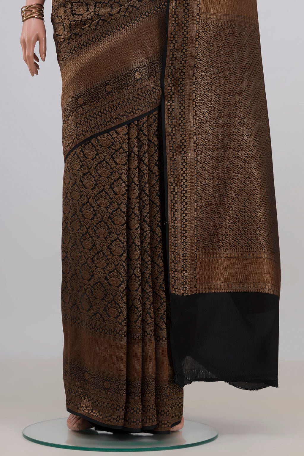 Pleats and pallu of Black Mysore Crepe Saree with Zari Brocade on the body and Zari Border. 