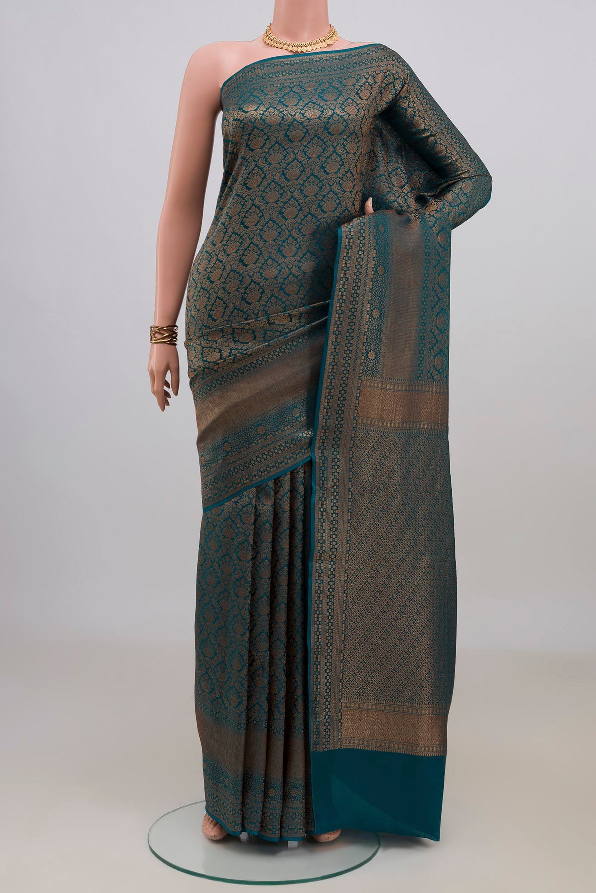 Teal Mysore Crepe Saree with Zari Brocade on the body and Zari Border.  displayed on a mannequin