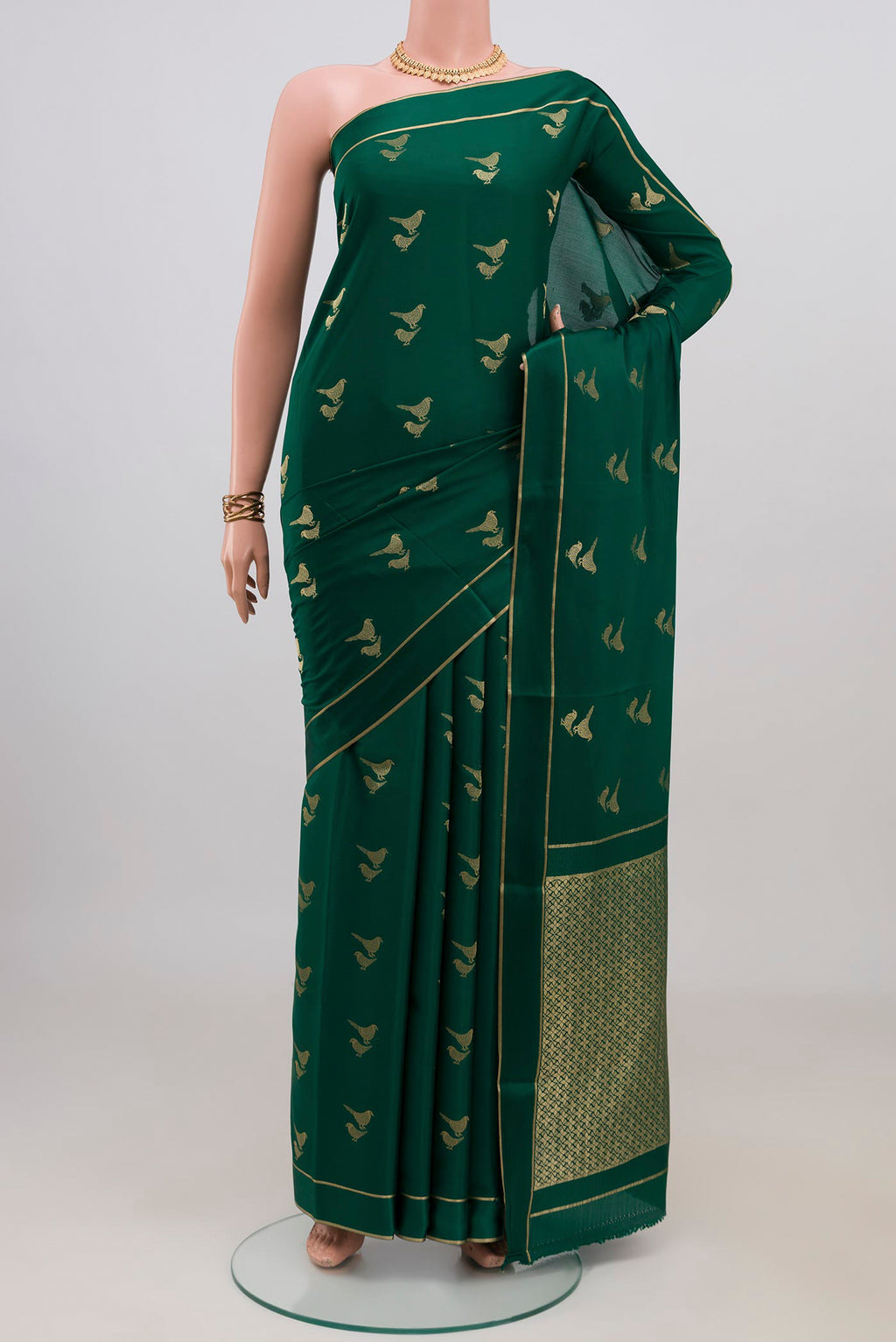 Green Mysore Crepe Saree with Zari Butta on the body and Thin Zari Line.  displayed on a mannequin