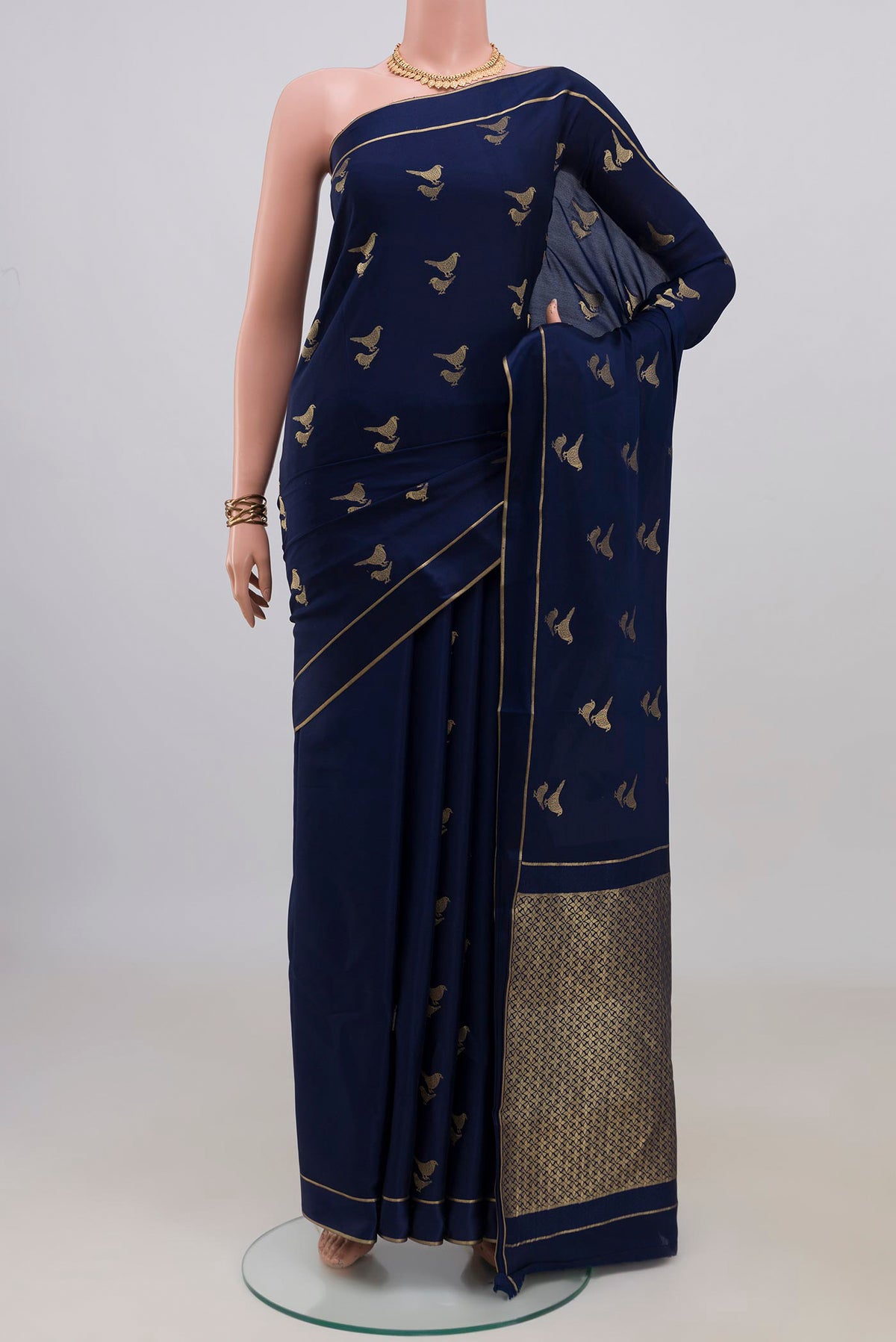 Navy Blue Mysore Crepe Saree with Zari Butta on the body and Thin Zari Line.  displayed on a mannequin