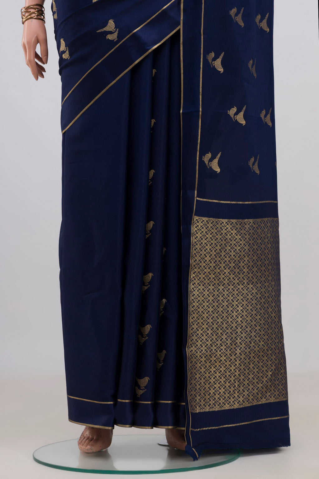 Pleats and pallu of Navy Blue Mysore Crepe Saree with Zari Butta on the body and Thin Zari Line. 