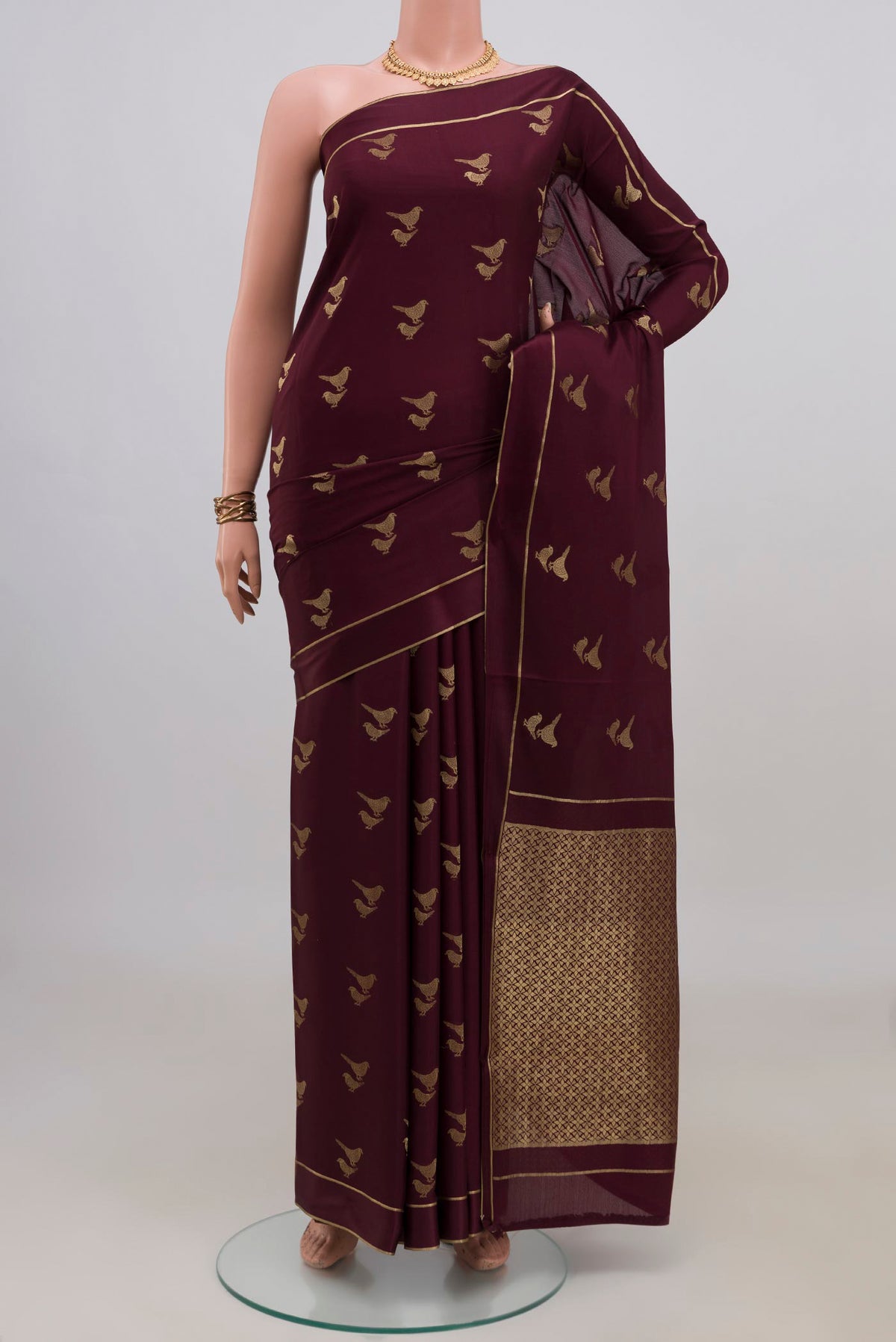 Coffee Brown Mysore Crepe Saree with Zari Butta on the body and Thin Zari Line.  displayed on a mannequin
