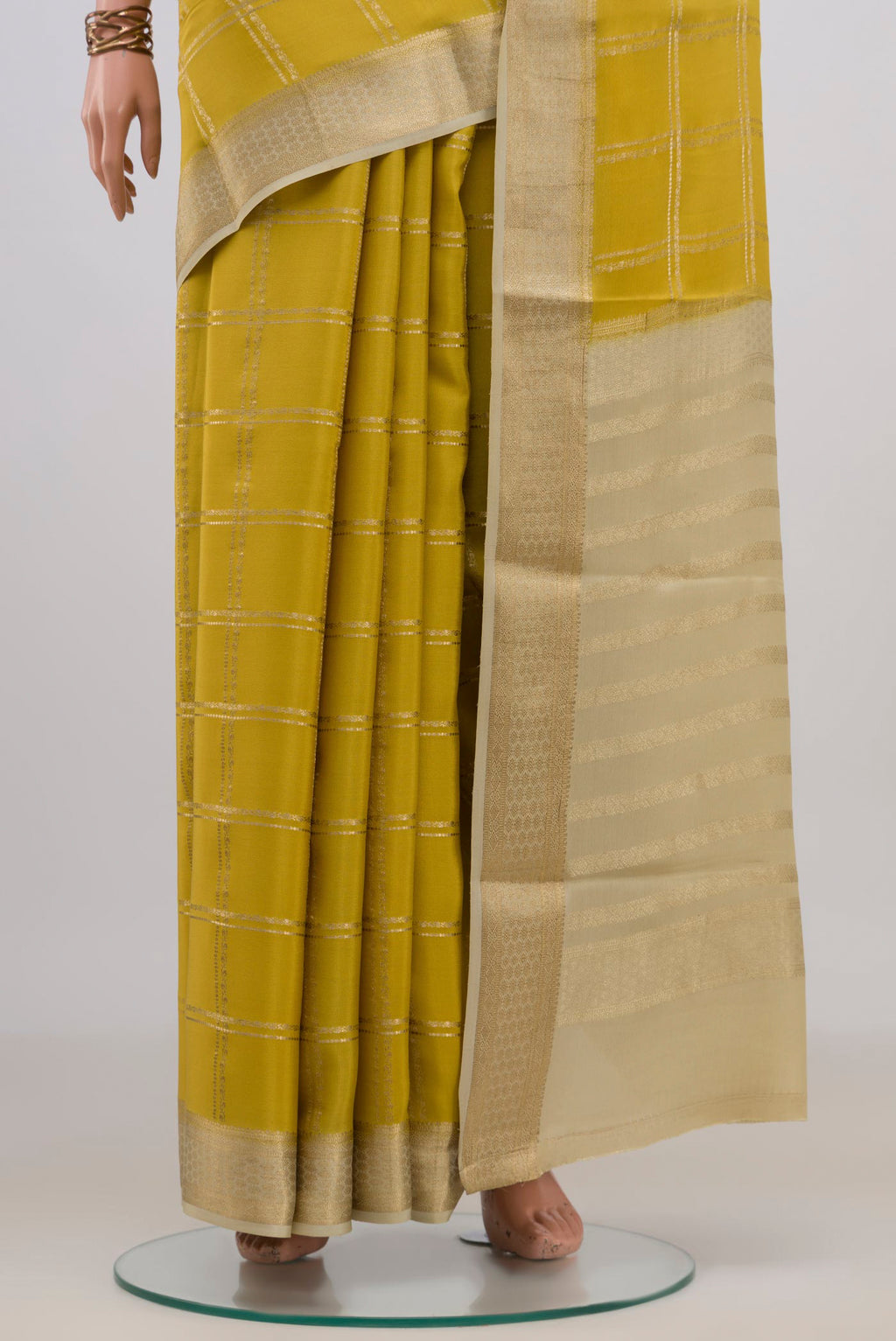 Pleats and pallu of Yellow Mysore Crepe Saree with Checked design on the body and Zari Border. 