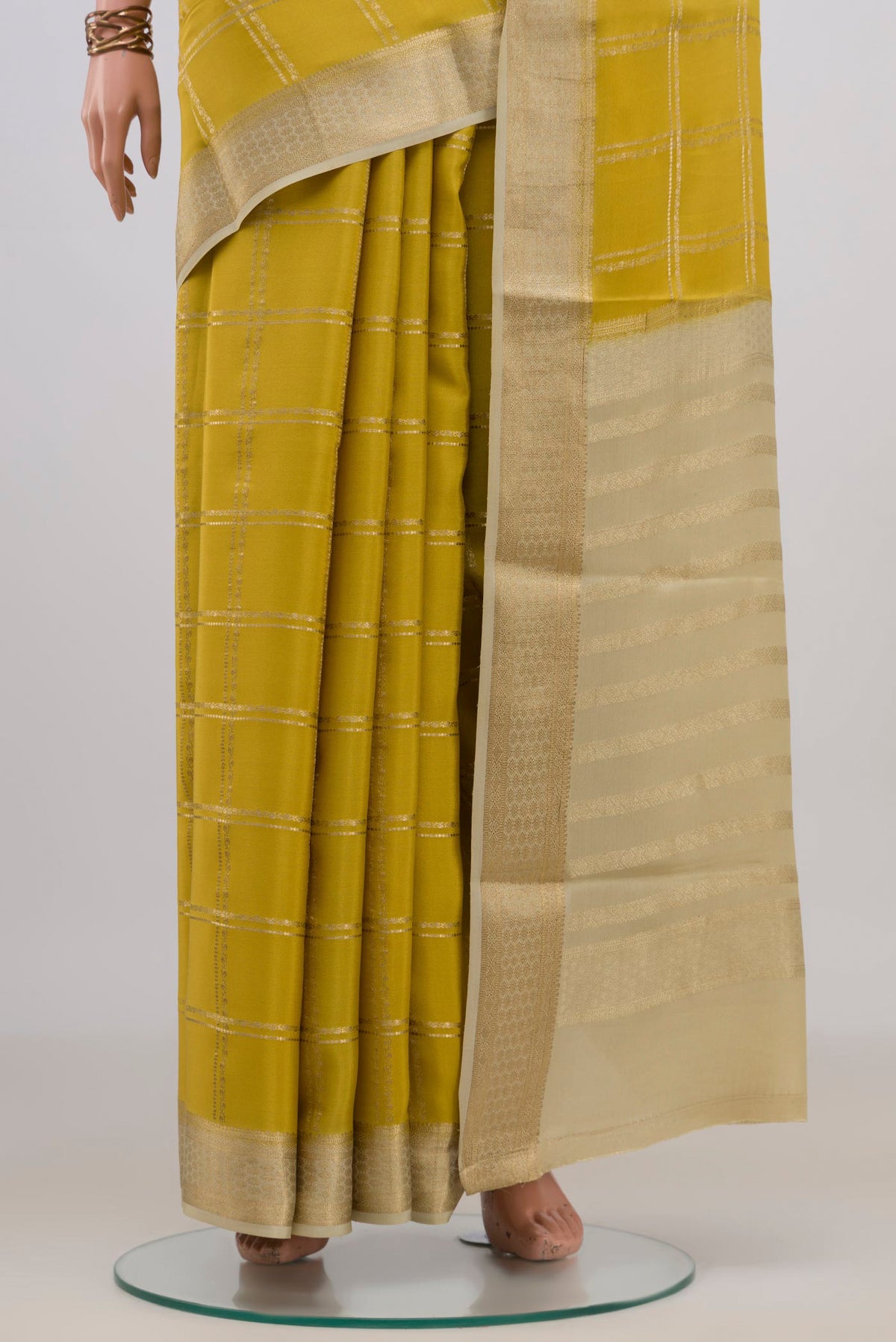 Pleats and pallu of Yellow Mysore Crepe Saree with Checked design on the body and Zari Border. 