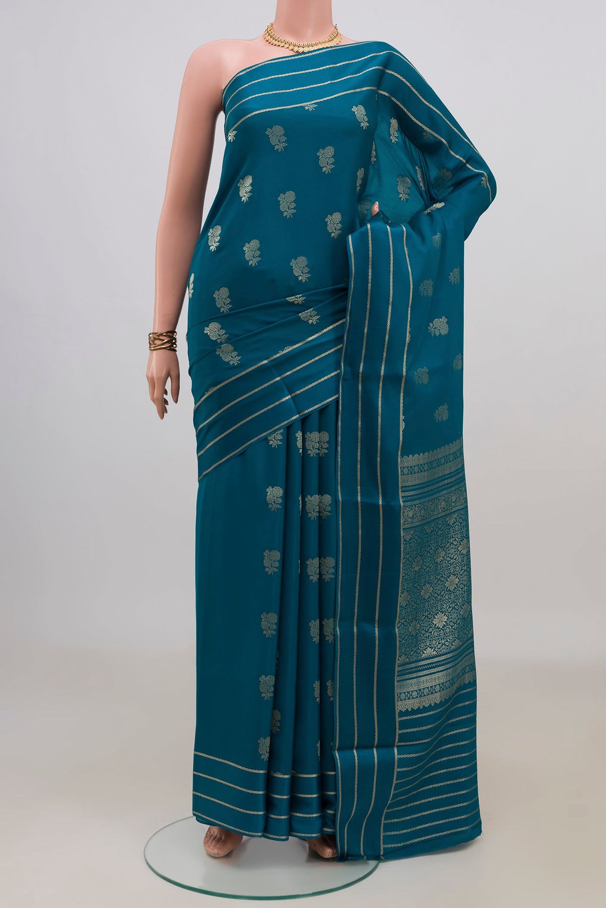 Blue Mysore Crepe Saree with Zari Butta on the body and Thin Zari Line.  displayed on a mannequin