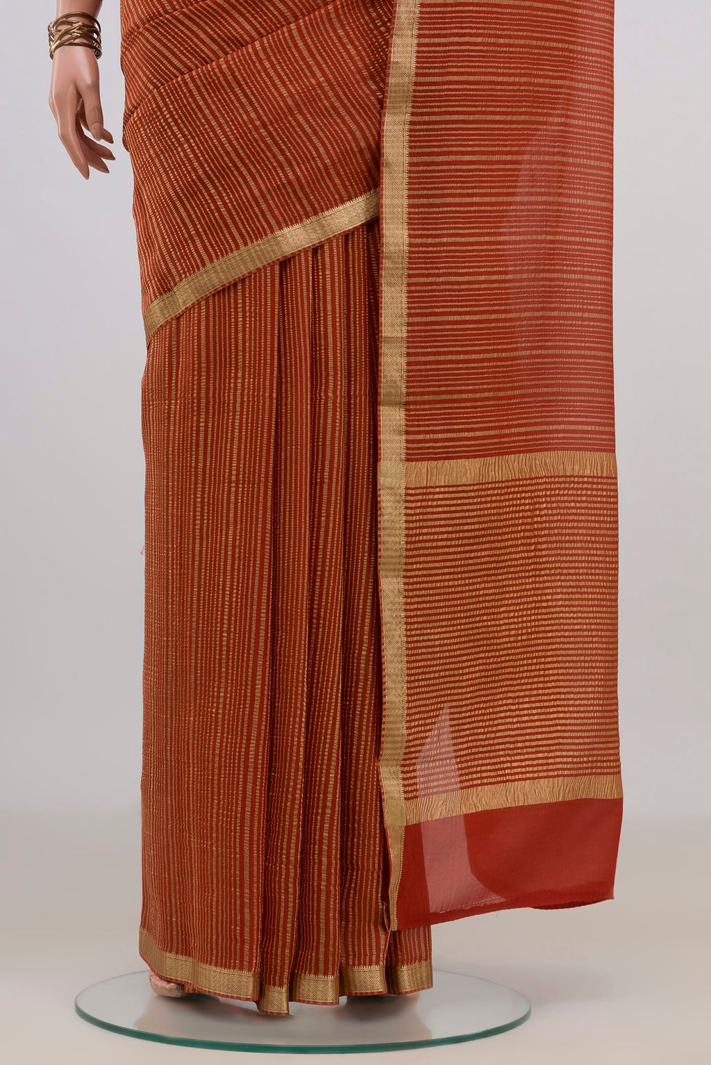 Pleats and pallu of Rust Mysore Georgette Saree with Stripes on the body and Thin Zari Line. 