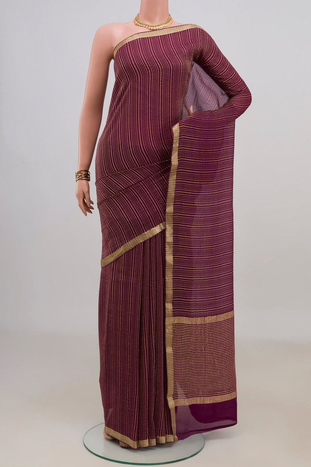 Magenta Mysore Georgette Saree with Stripes on the body and Thin Zari Line.  displayed on a mannequin